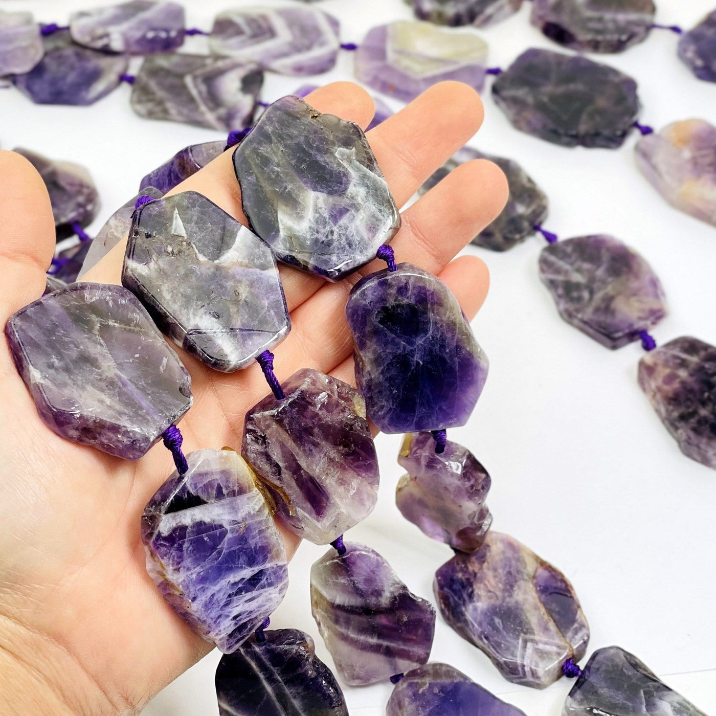 Chevron Amethyst slab beads - Polished Beads--stone slap beads in hand for size comparison.