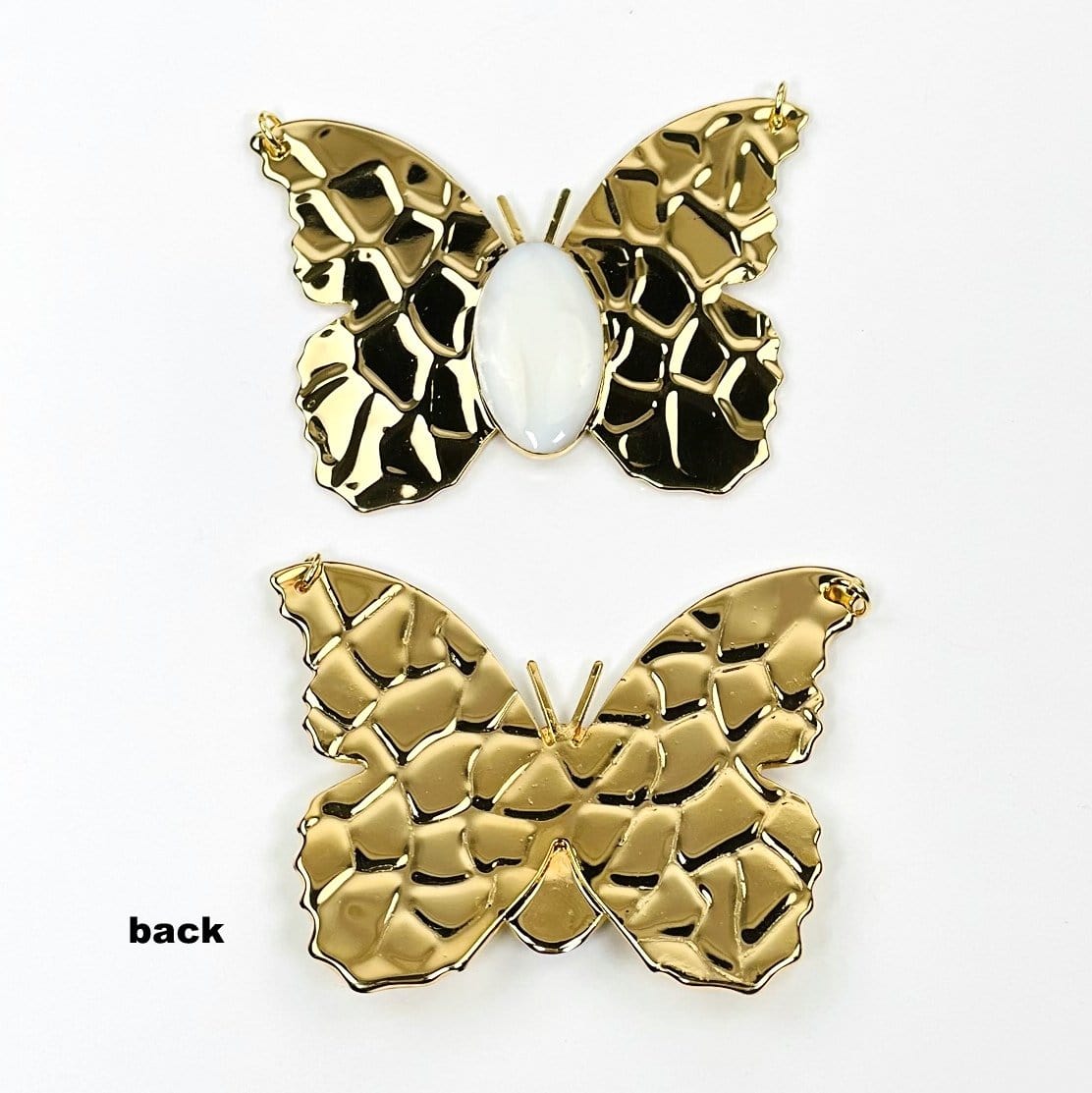 gold butterfly pendants with a mother of pearl center displaying front and back 