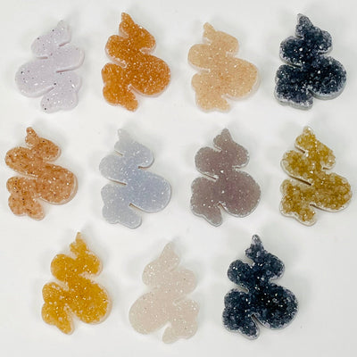multiple snake shaped cabochons displayed to show the differences in the color shades 
