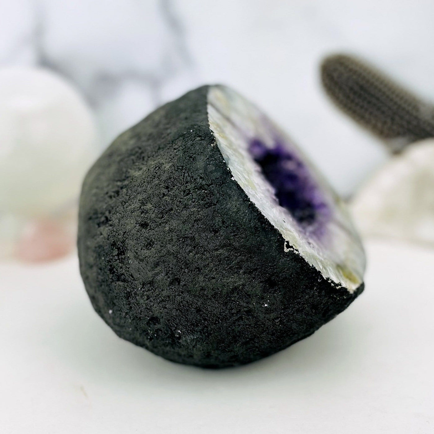Side view of the amethyst geode showing the black along the back and edges.