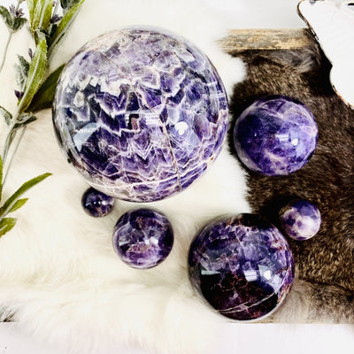 Chevron Amethyst Polished Spheres of varying sizes on display