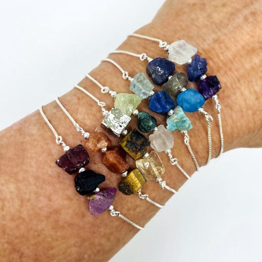 chakra themed three stone adjustable bracelets in silver on wrist for size reference 