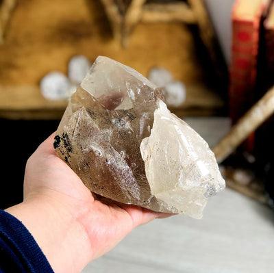 back view of smokey quartz raw point in hand