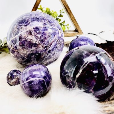 Chevron Amethyst Polished Spheres on display, showing varying sizes