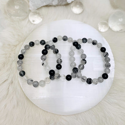Black Rutilated Round Bead Bracelets  - 3 on a table