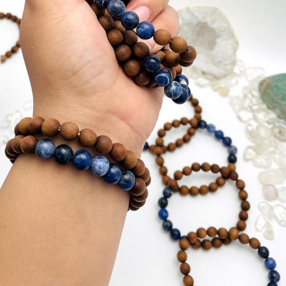 sandalwood bead bracelets with sodalite on wrist and on display for size reference