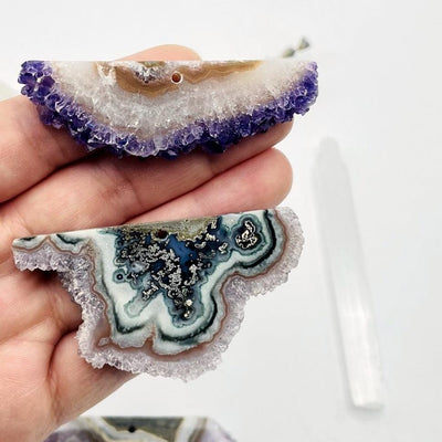 hand holding up 2 Amethyst Stalactite Slices