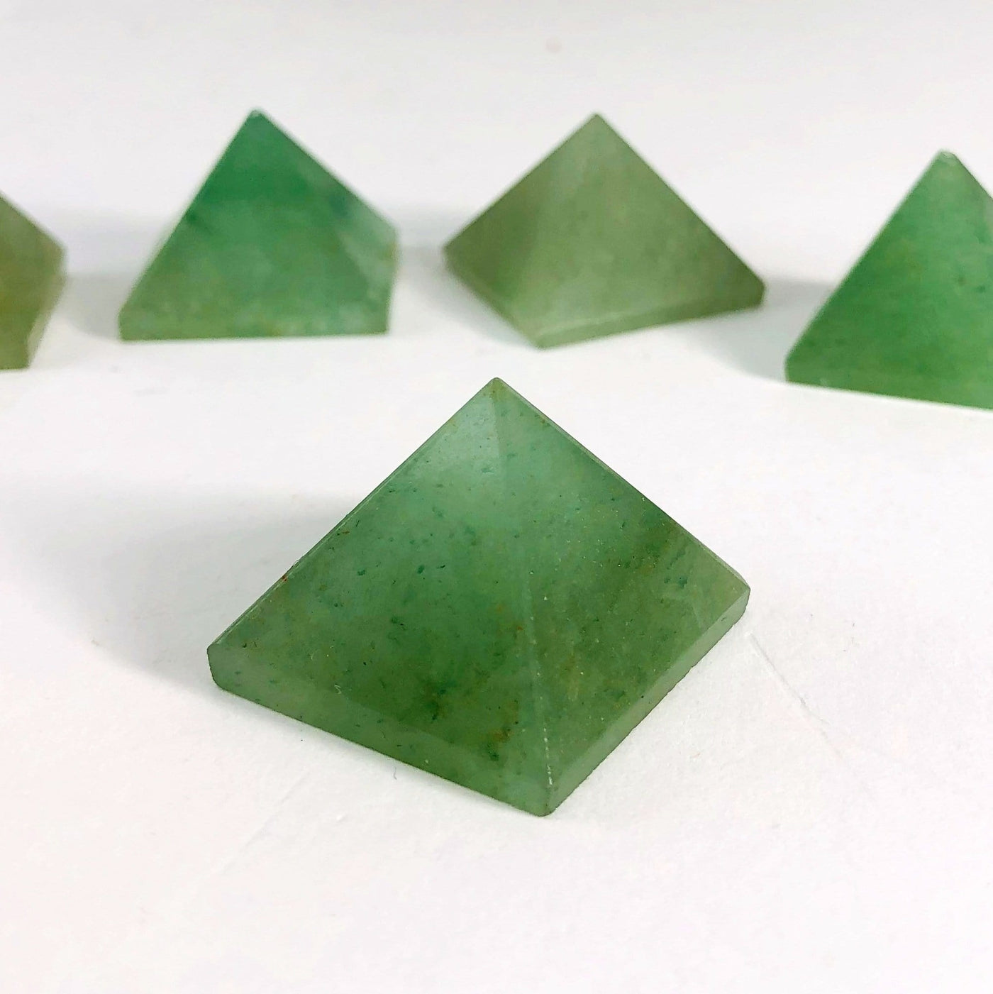 Green Aventurine Pyramids in a row with one up close