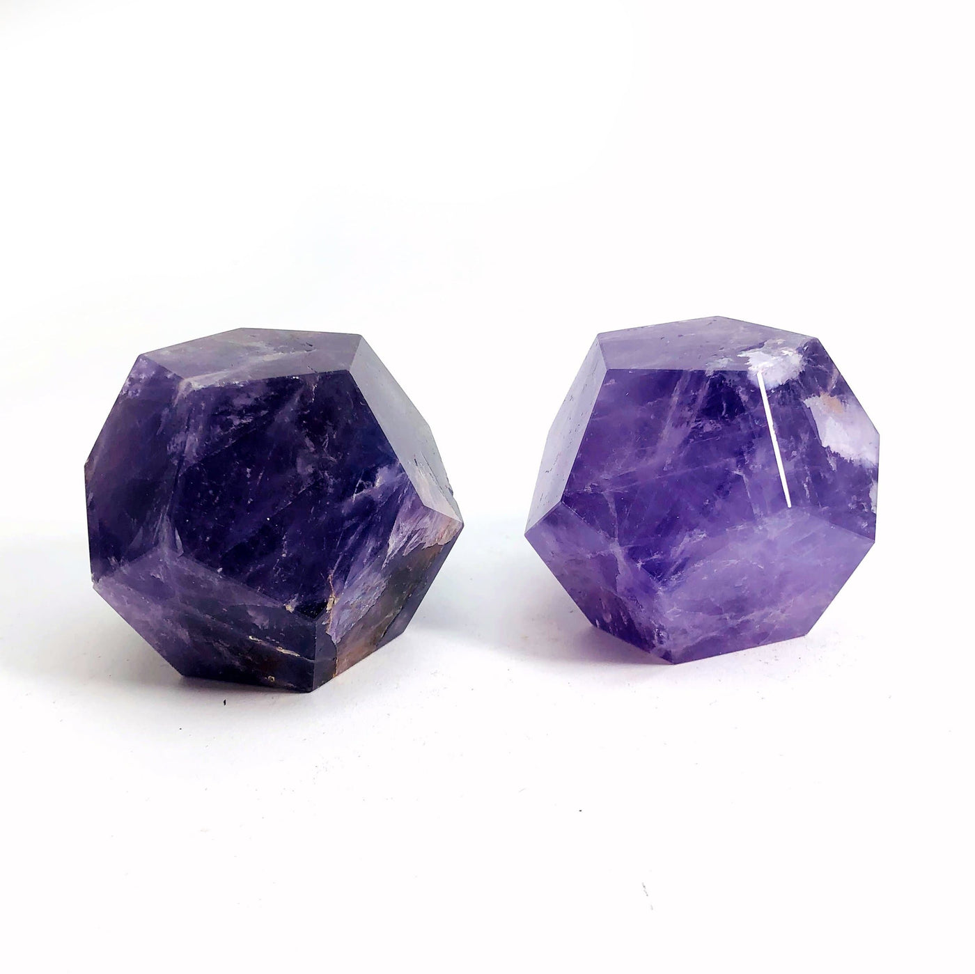 2 Amethyst Dodecahedrons on white background