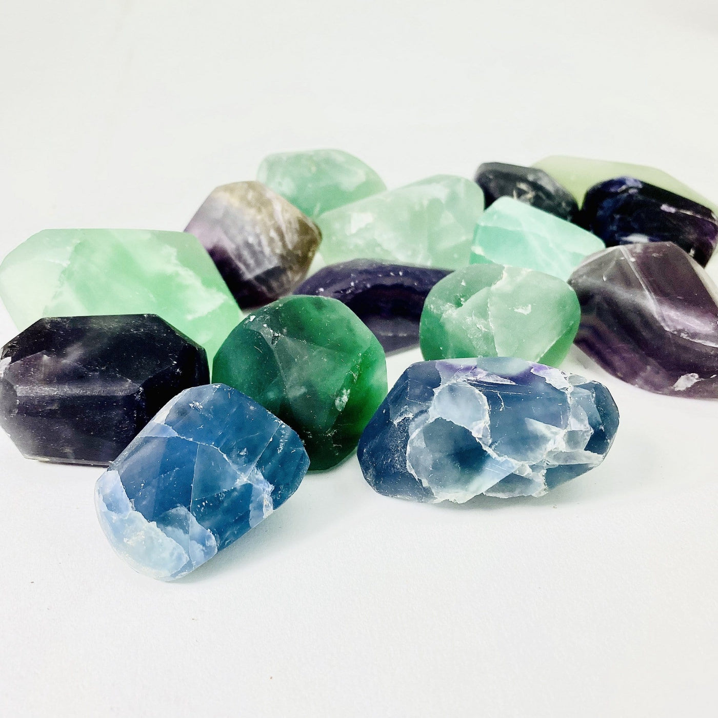 side view of pile of Rainbow Fluorite Tumbled Stones