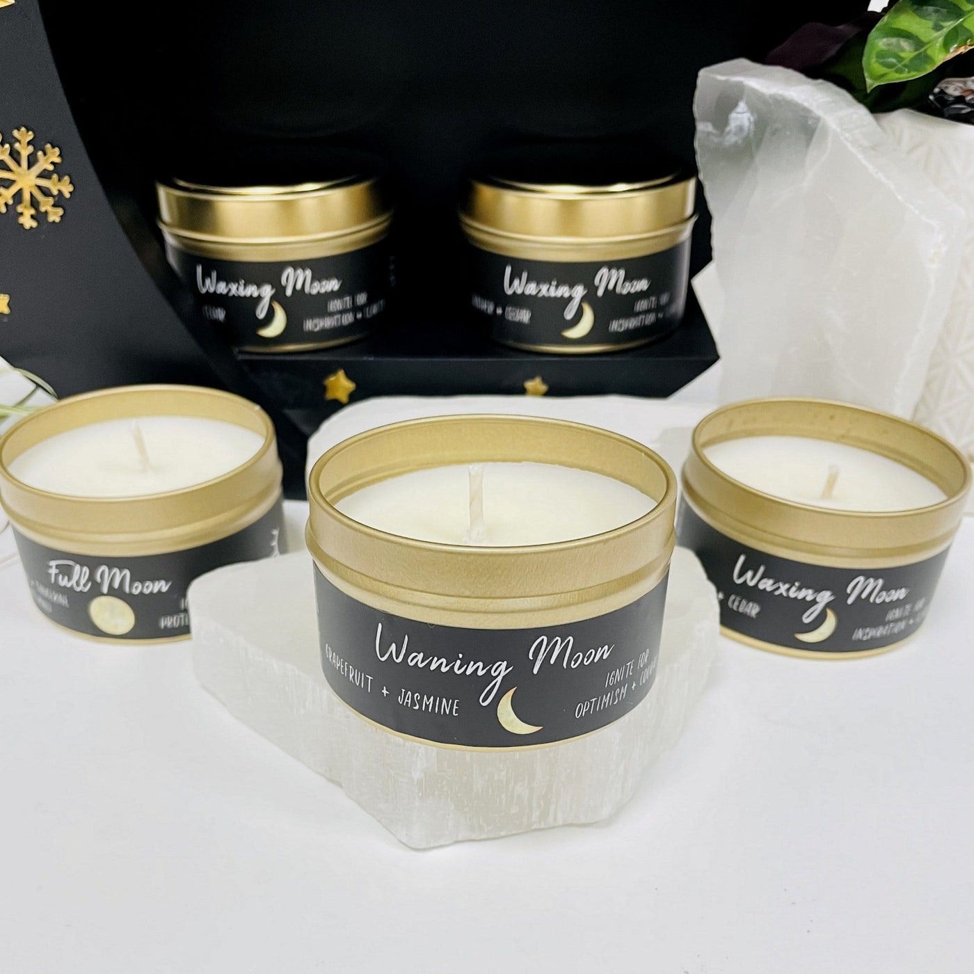 3 moon phase candles with decorations in the background