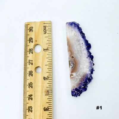 Amethyst Stalactite Slice next to a ruler for size reference