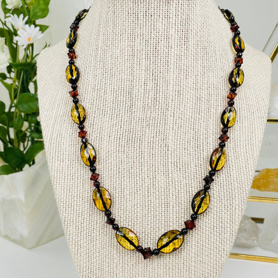 amber necklace displayed to show the differences in the color shades of amber 