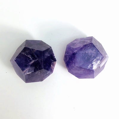 top view of 2 Amethyst Dodecahedrons on white background