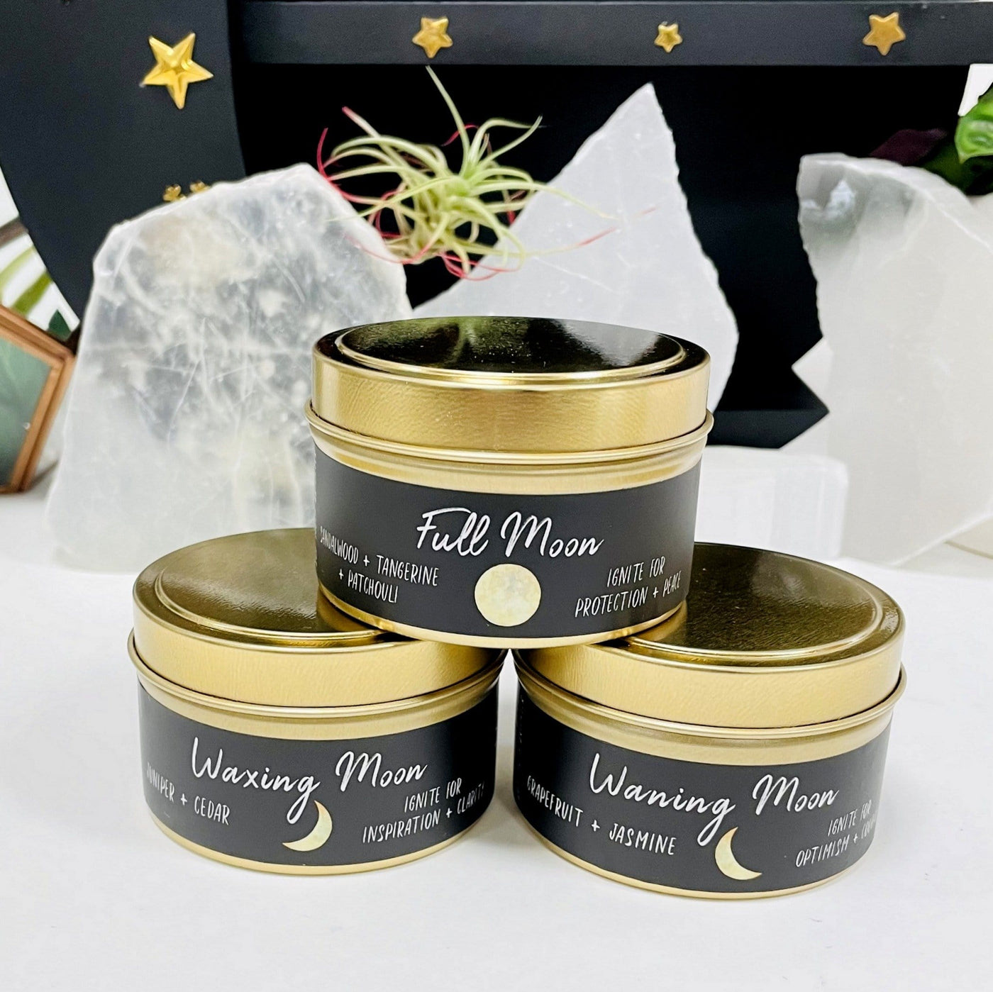 2  moon phase candles with decorations in the background