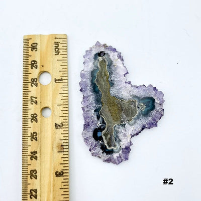 Amethyst Stalactite Slice next to a ruler for size reference