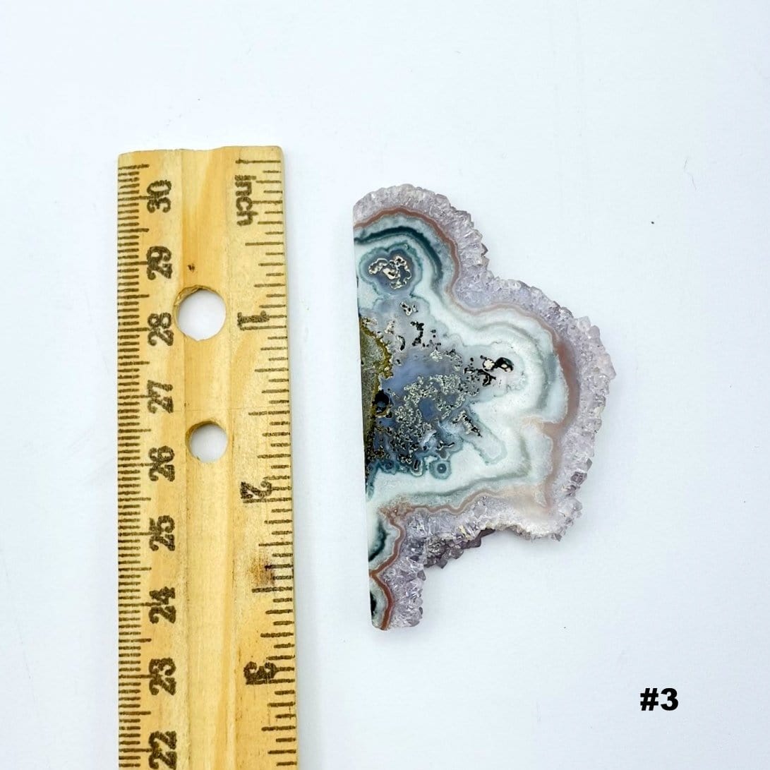 Amethyst Stalactite Slice next to a ruler for size reference