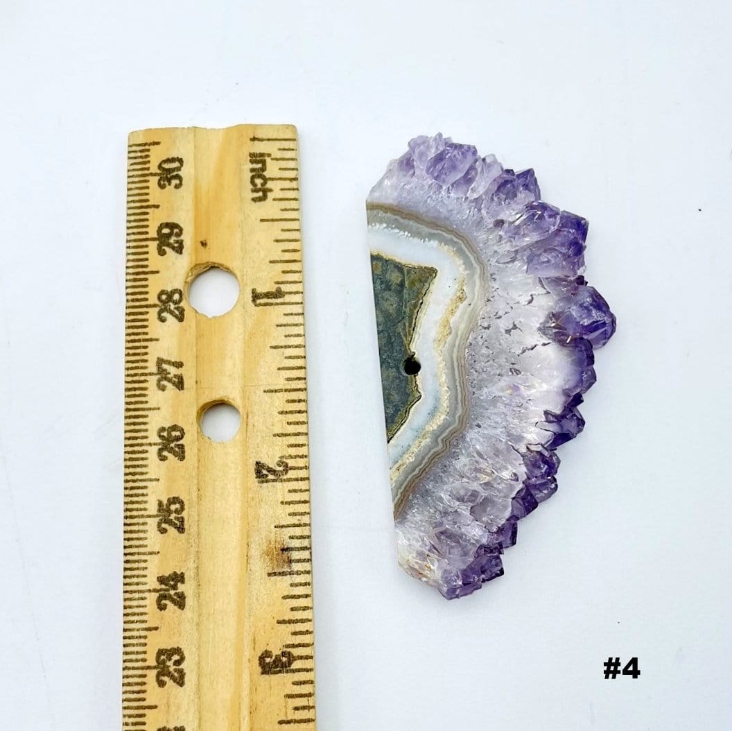 Amethyst Stalactite Slice next to a ruler for size reference