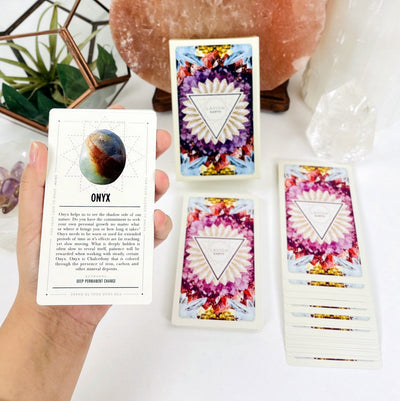 Lavish Earth Crystal Affirmation Card Deck  displayed on white background in hand to show card size