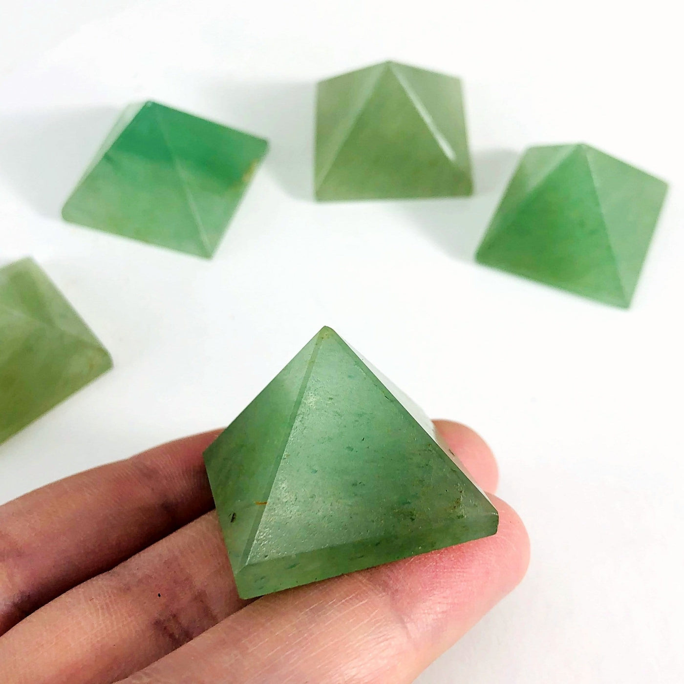 Green Aventurine Pyramid in a hand viewed from a side view