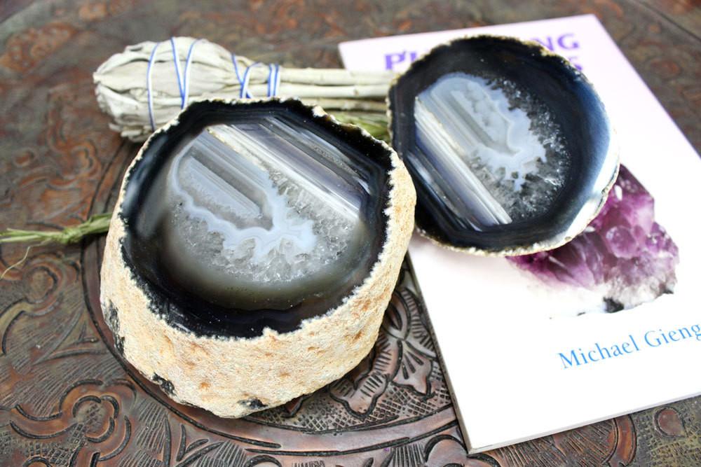 2 Halfs of a geode open on top of a book revealing the middle.