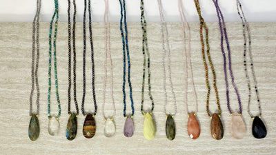 stone teardrop necklaces on a table