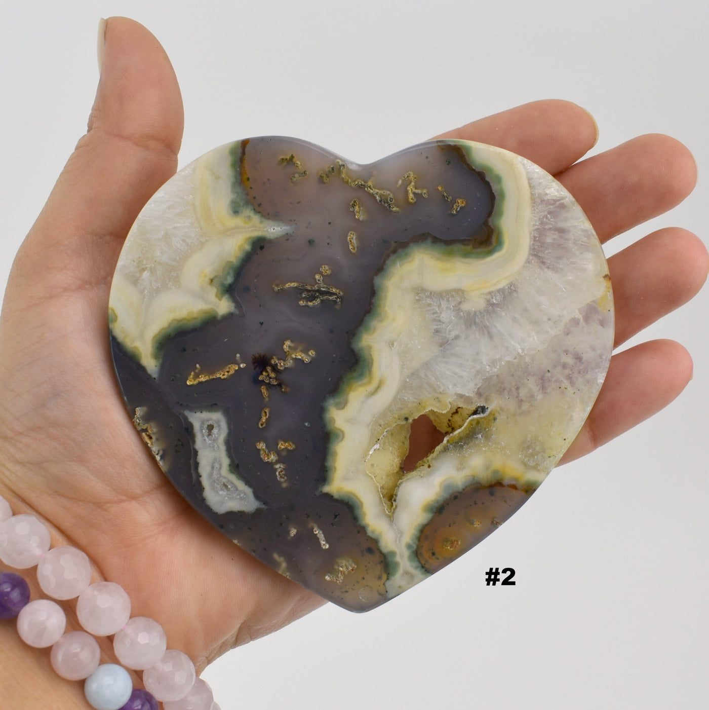 Close up of agate heart slice #2 in a hand.