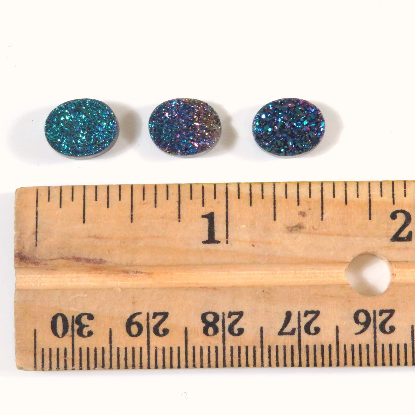 Titanium Coated Round Rainbow Druzy Cabochons next to ruler for size reference