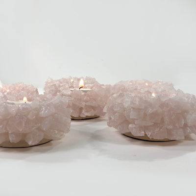 Side view of 3 Rose Quartz Candle Holders on white background