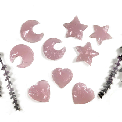 3 Rose Quartz Colored Glass Hearts Moons and Stars with plants on a white background