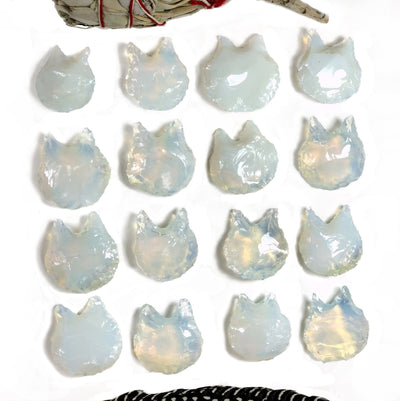 16 opalite cats on a white background