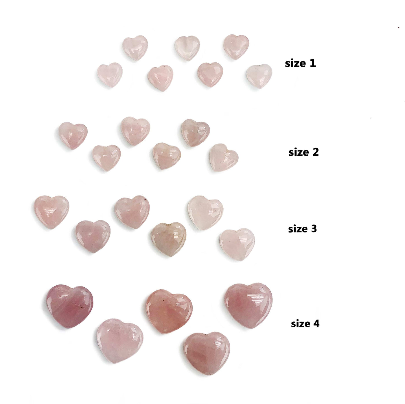 Rose Quartz Hearts separated by size on white background