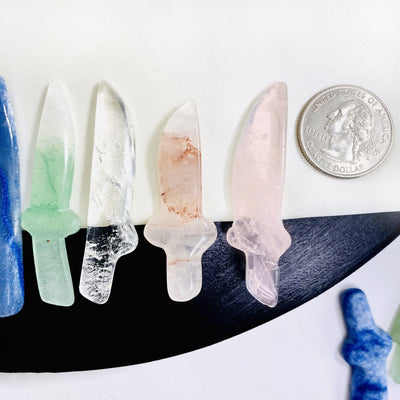 Crystal Gemstone Knife Cabochons next to a quarter for size reference