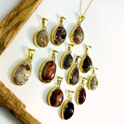 Mexican opal pendants in gold on white background