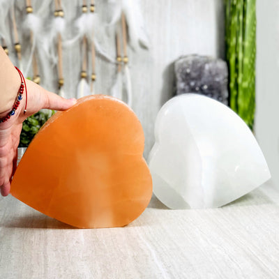 selenite heart shaped lamp with hand for size reference