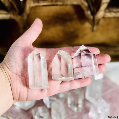 Crystal Quartz Polished Cut Base Points in a hand for the 40-80g size