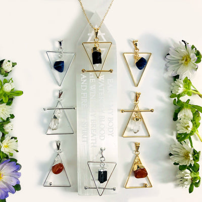 All the Gold and Silver element pendants displayed next to each other showing different stones and patterns 