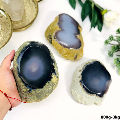 800g-3kg Agate Enhydro Semi-Polished Geode shown in a hand within an alter.