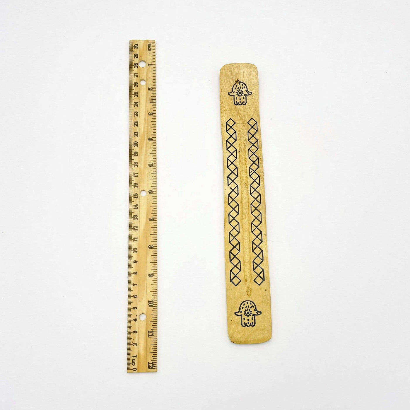 Wooden Incense Burner with Hamsa hand accent next to a ruler for size reference