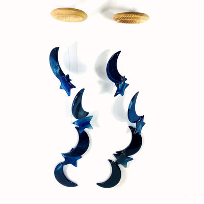 Two blue Agate Moon and Star Wind Chimes on a white background.