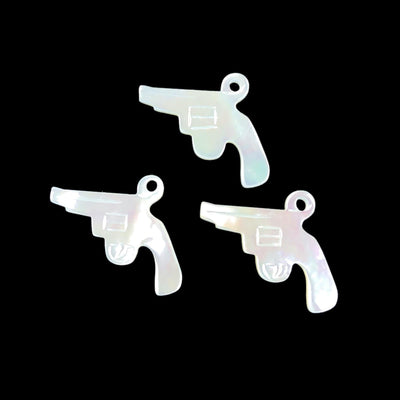 3 mother of pearl guns displayed on black background to view characteristic differences between each bead