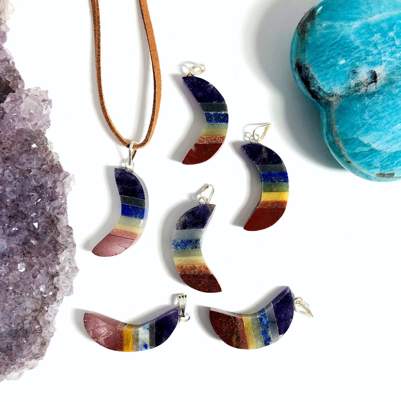 multiple moon pendants displayed to show the slight differences in the stones