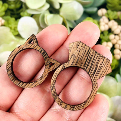 Wooden Cat and Ring Shaped Rings in a hand