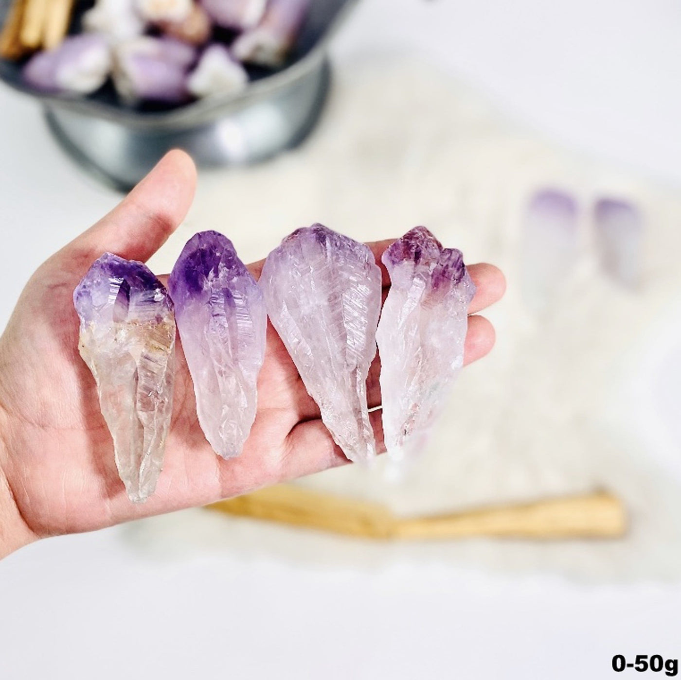 4 amethyst points in a hand