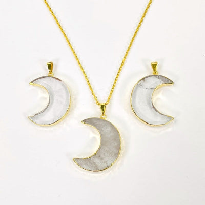 3 crystal quartz half moon pendants with one on gold necklace chain