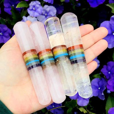 four seven chakra polished wand in hand (two in rose quartz and two in crystal quartz) for size reference and possible variations