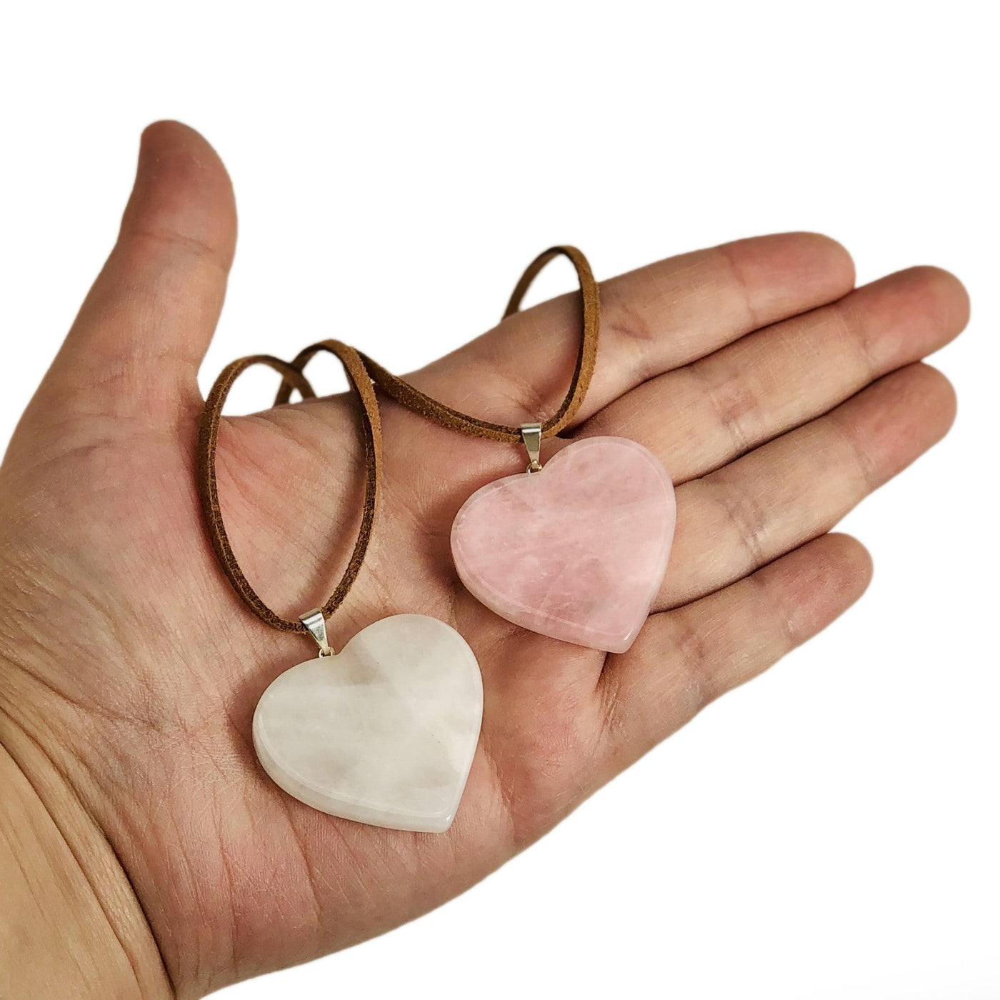 two heart slice pendants with silver toned bail with string on them to show as a neckless