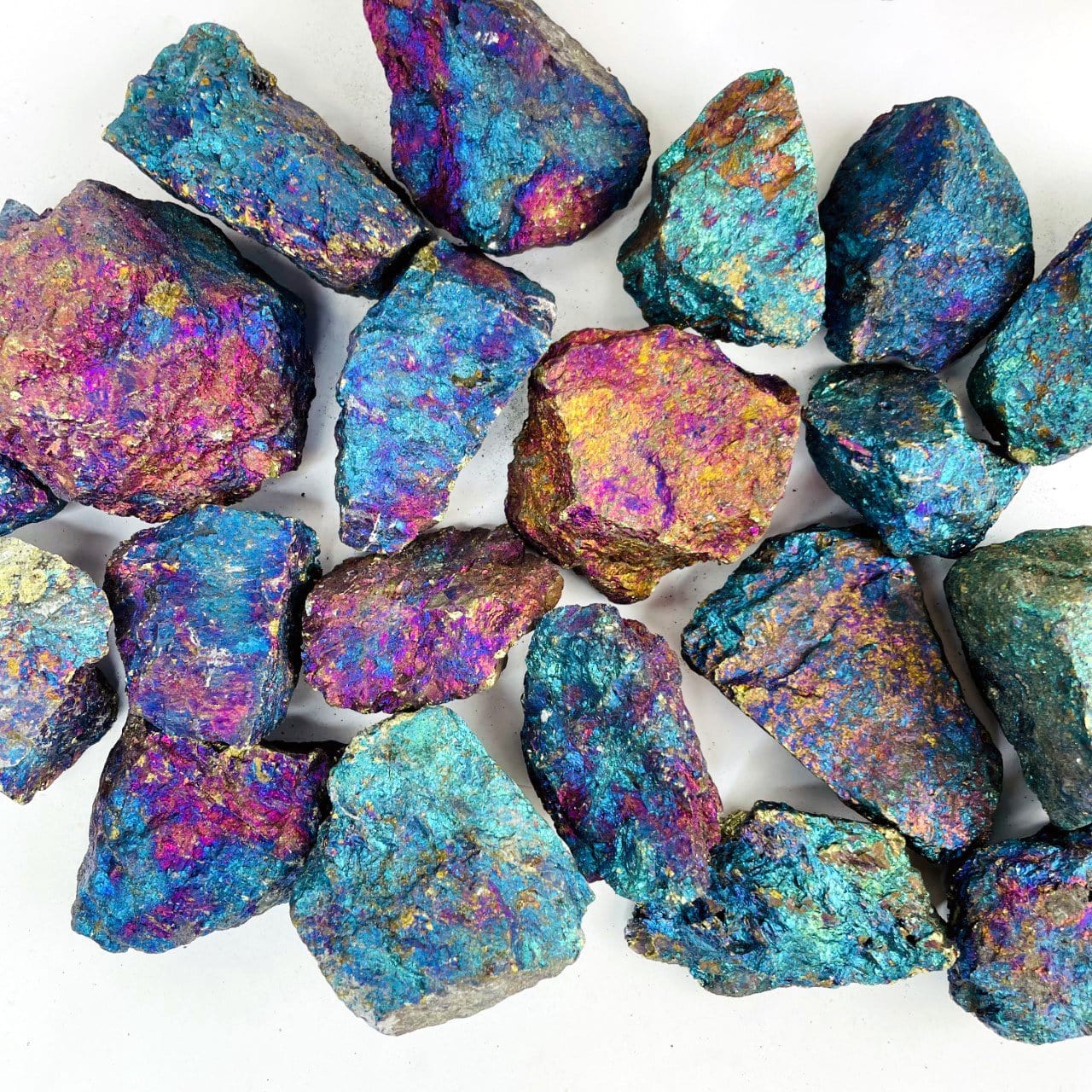 Close up of Peacock Ore rough stones beautiful shades of blue, purple, pink, and yellow