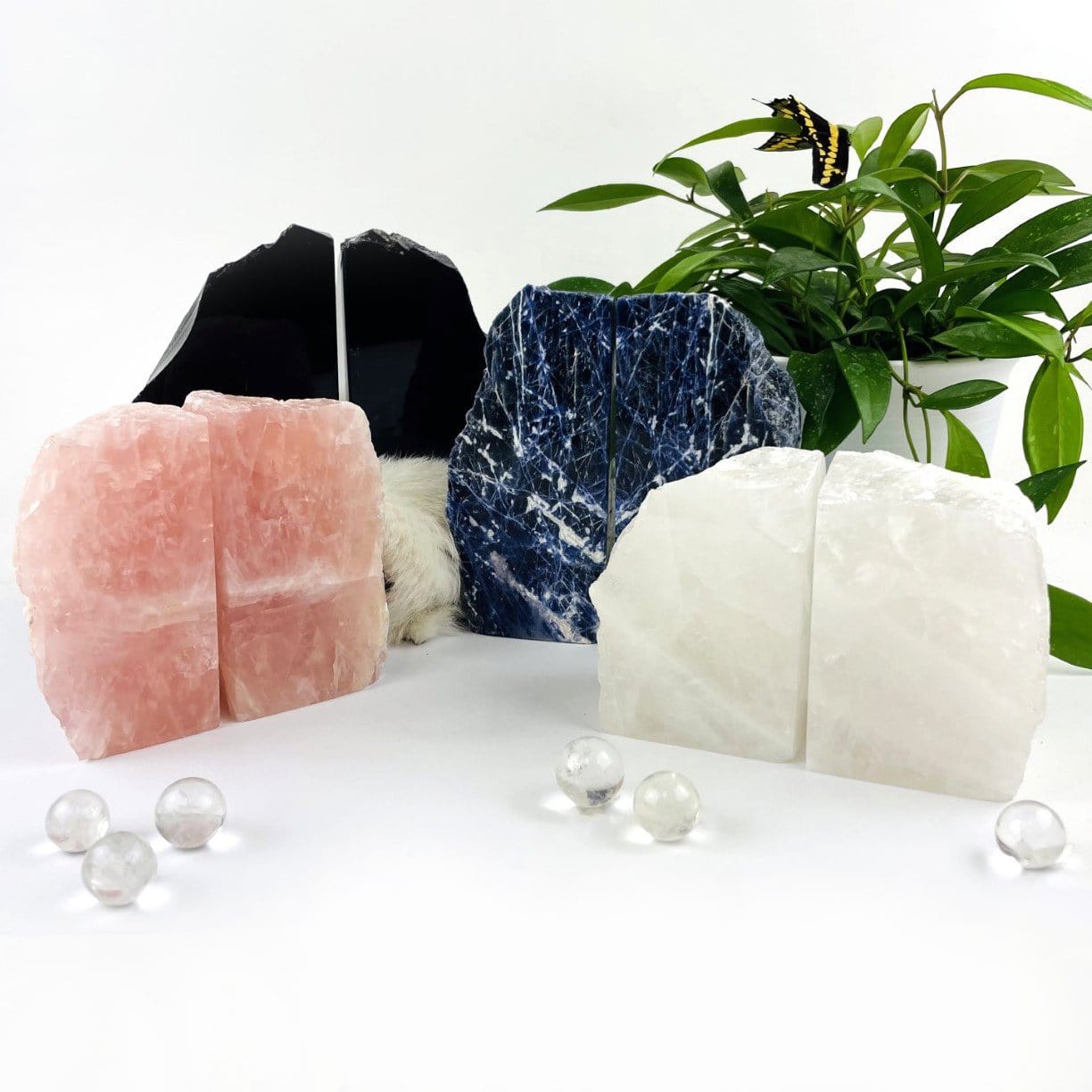 A photo showing all of our stone bookends on a white background.  PIctured are Rose Quartz, Crystal Quartz, Sodalite and Black Obsidian bookends.
