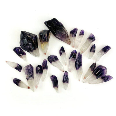 Polished Amethyst Points spread out on a table showing variation of sizes